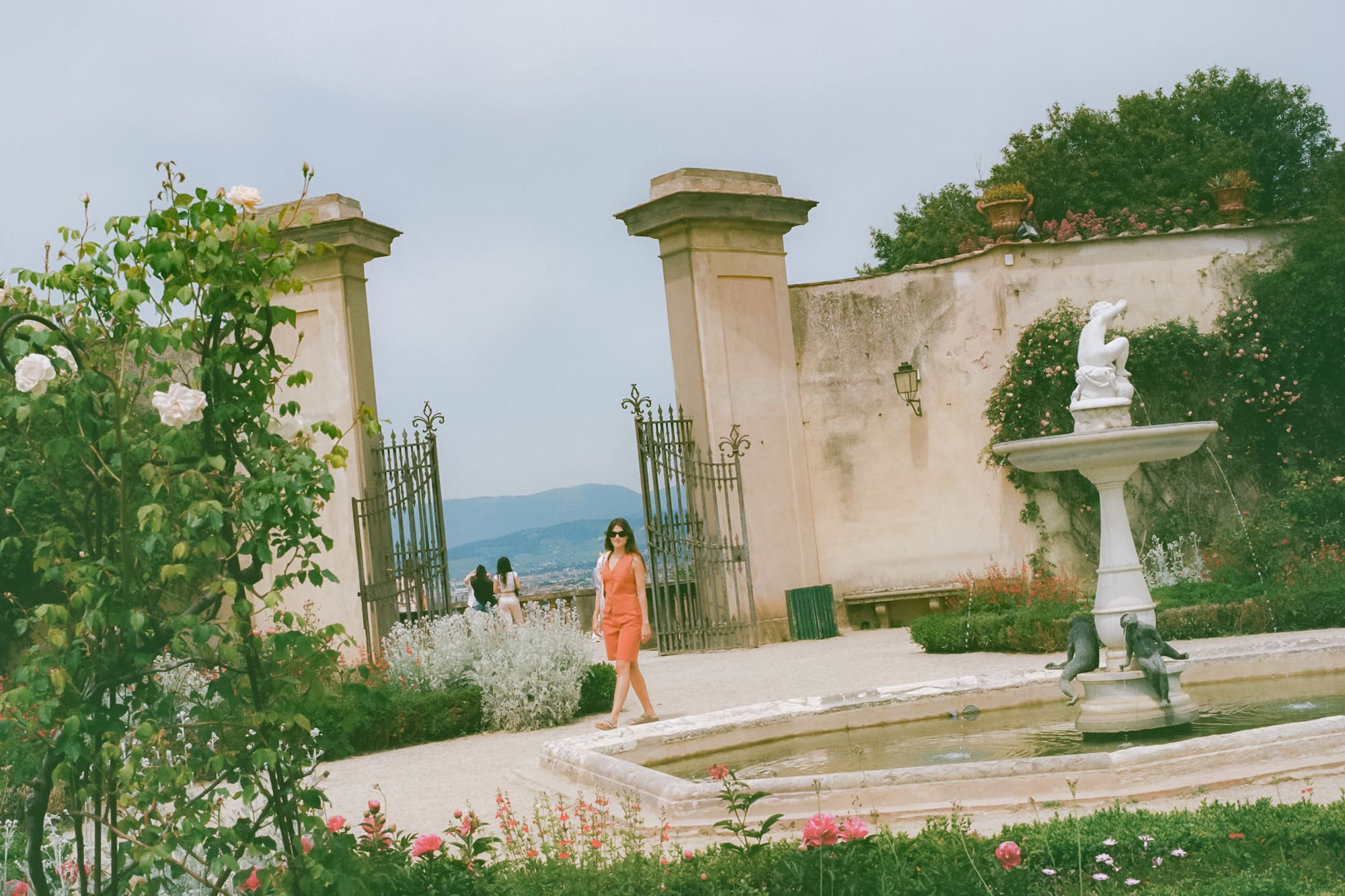 a woman standing in front of a fountain