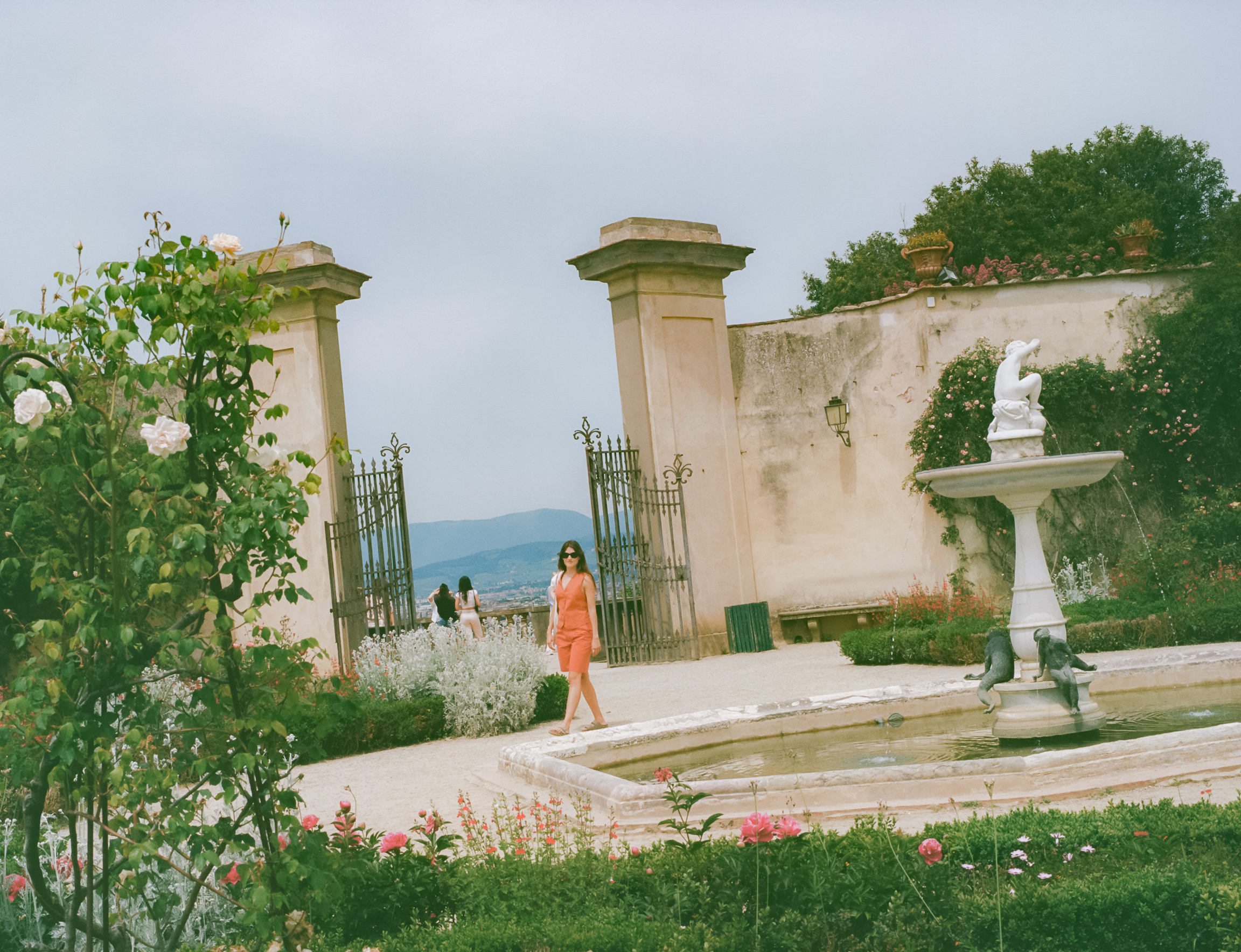 a woman standing in front of a fountain