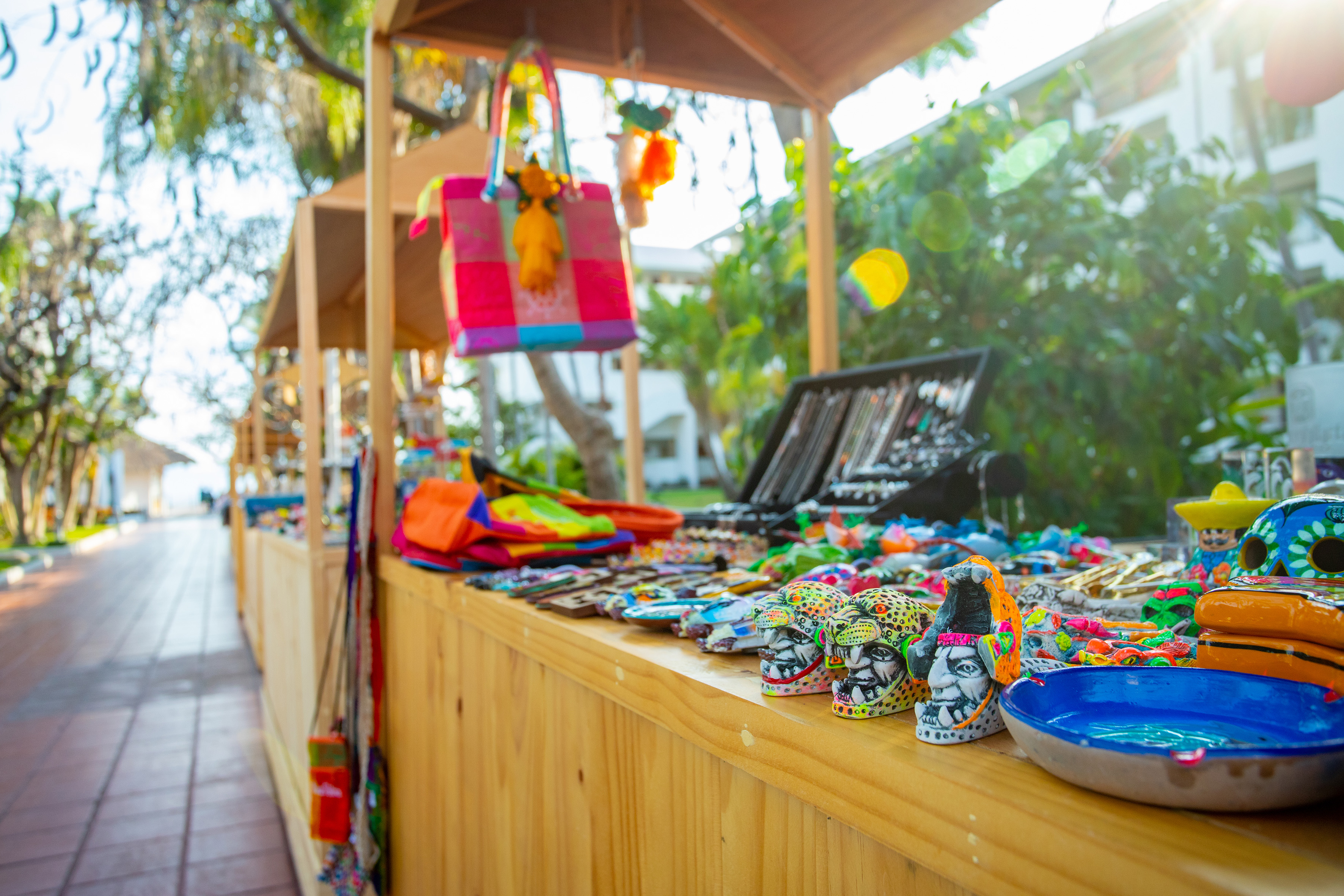 Outdoor market stall showcasing colorful artisan souvenirs and crafts.