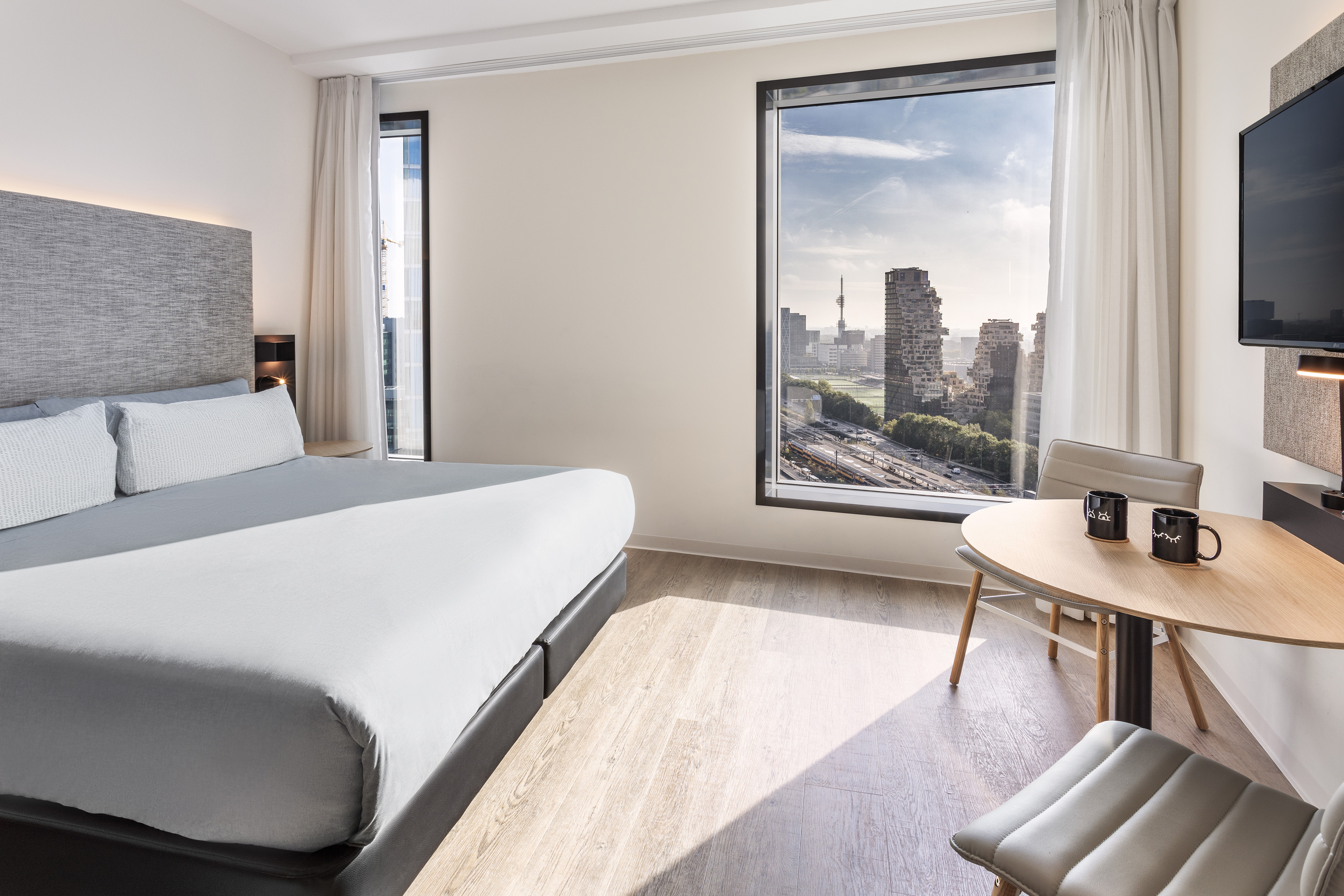 a room with a large window and a bed