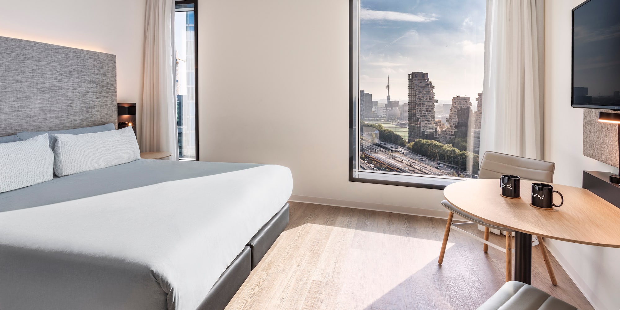 a room with a large window and a bed