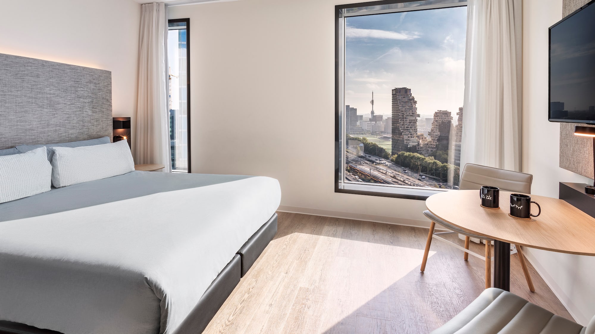 a room with a large window and a bed