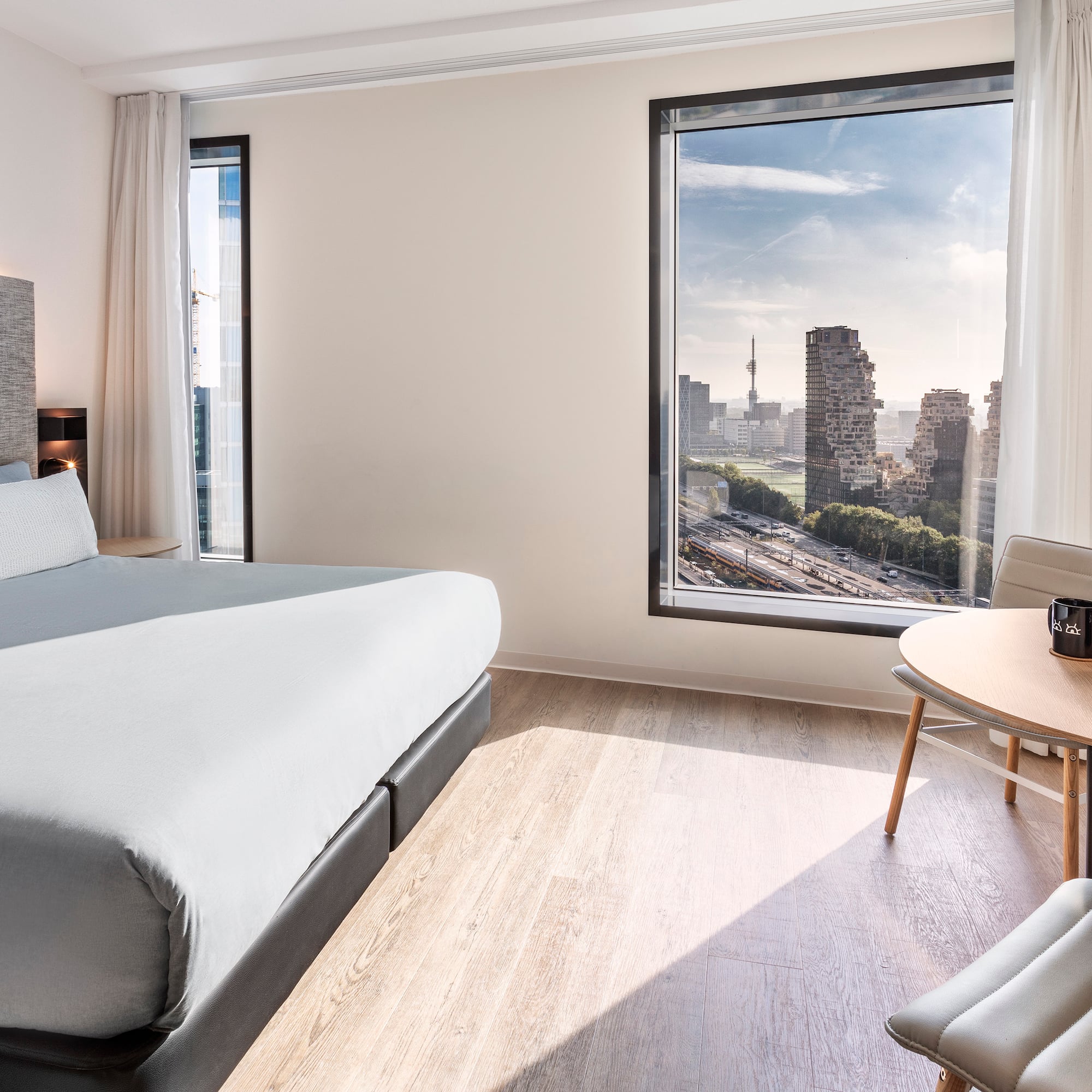 a room with a large window and a bed