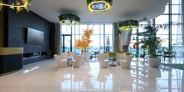 a room with white chairs and a television