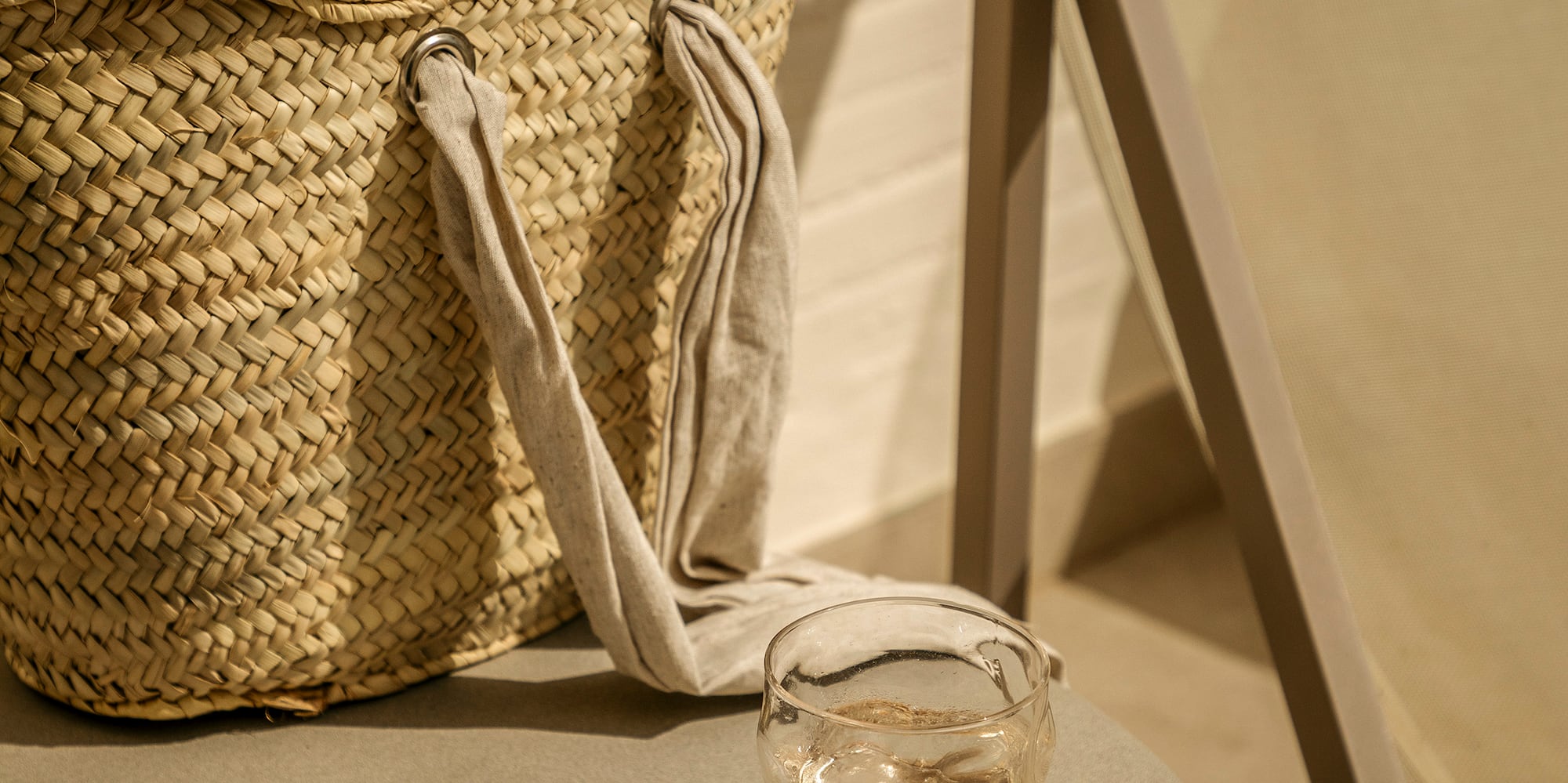 a bag with flip flops and sunglasses on a table