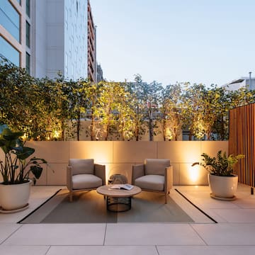 a patio with chairs and a table