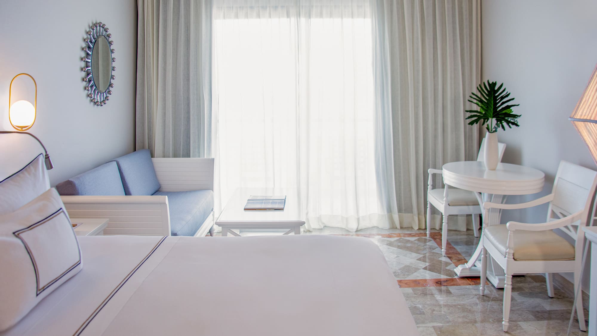 a room with a bed and a table and chairs