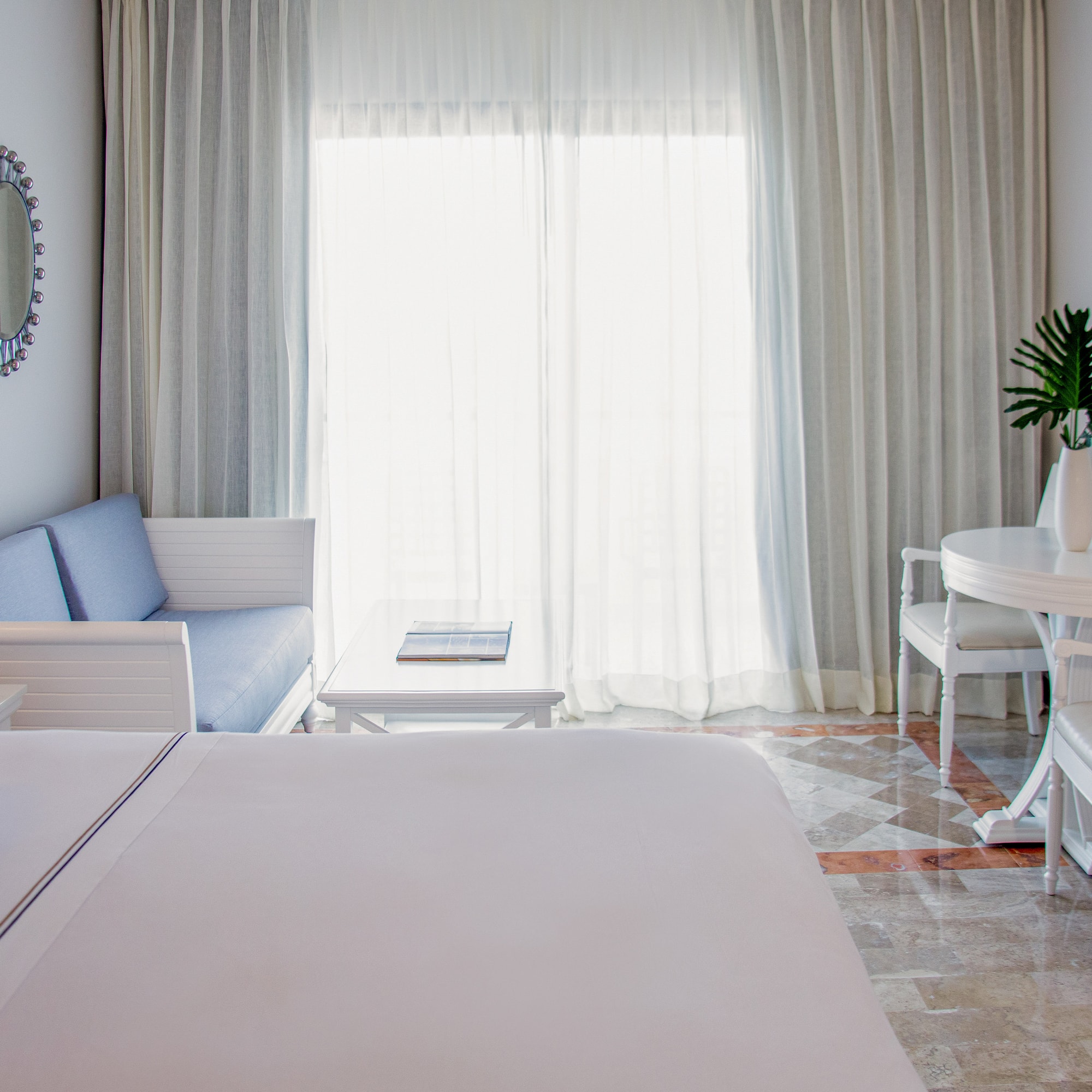 a room with a bed and a table and chairs