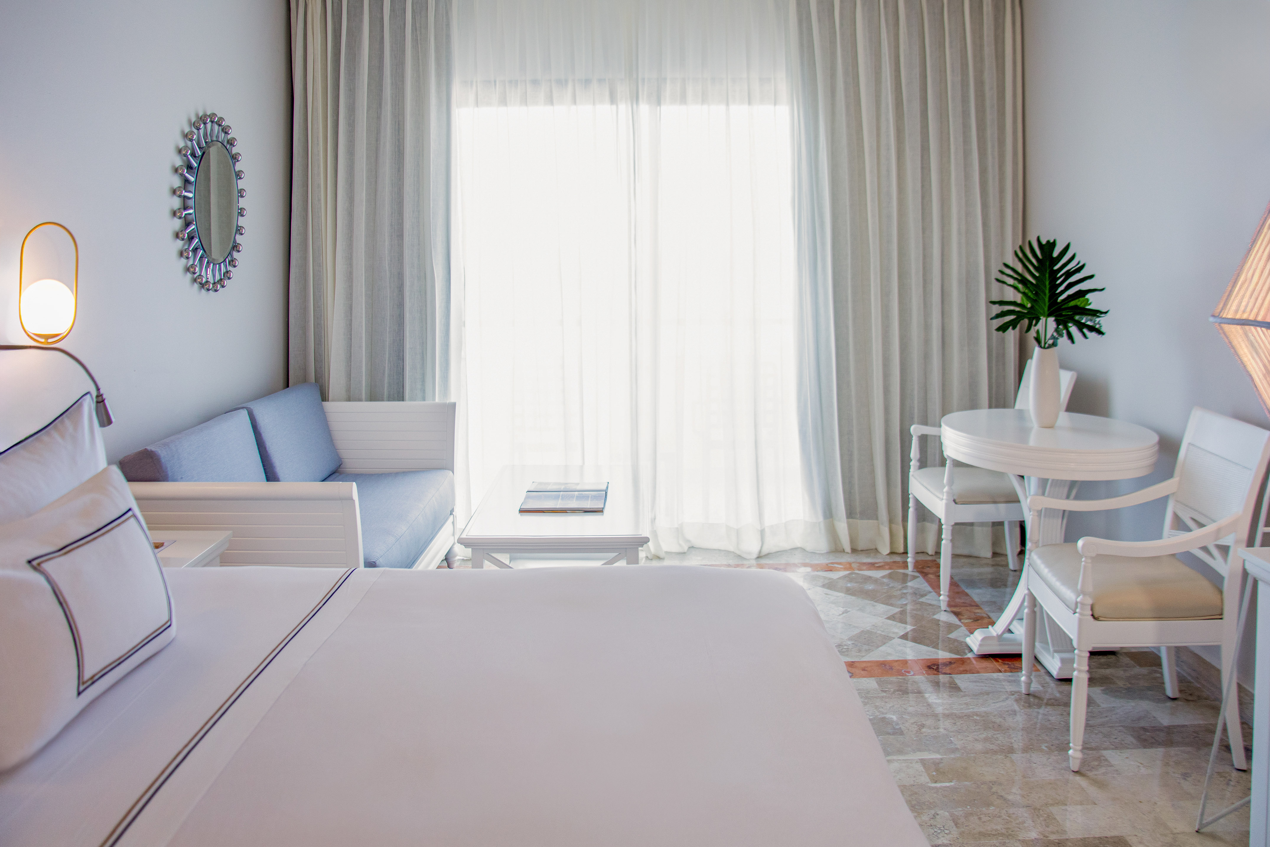 a room with a bed and a table and chairs