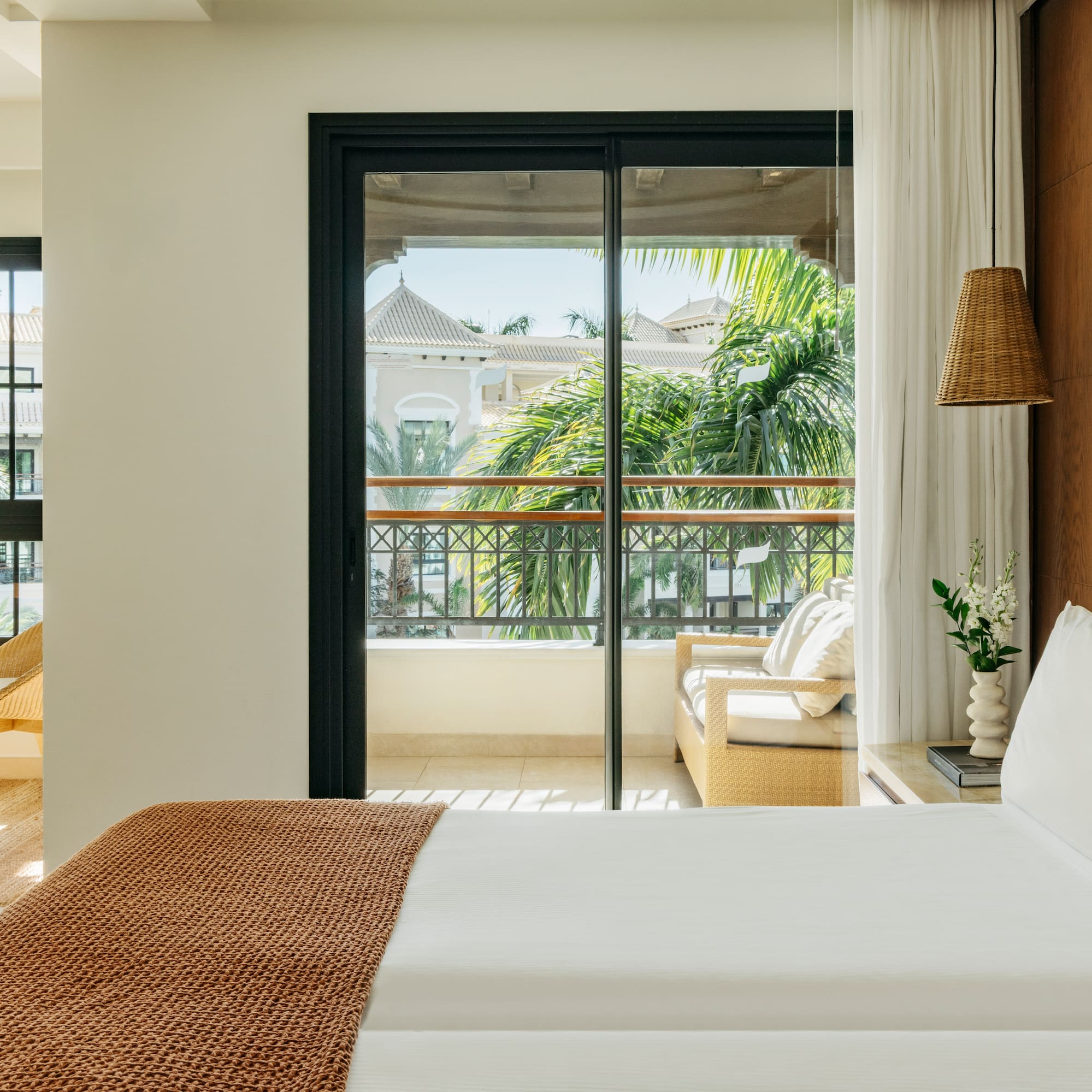 a bed with a brown blanket and a brown lamp