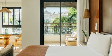 a bed with a brown blanket and a brown lamp
