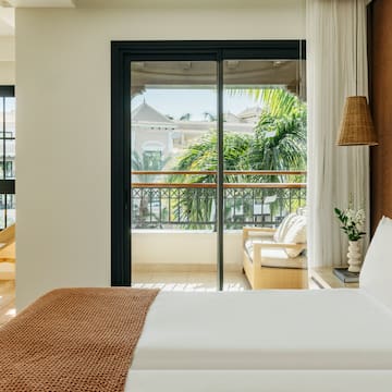 a bed with a brown blanket and a brown lamp