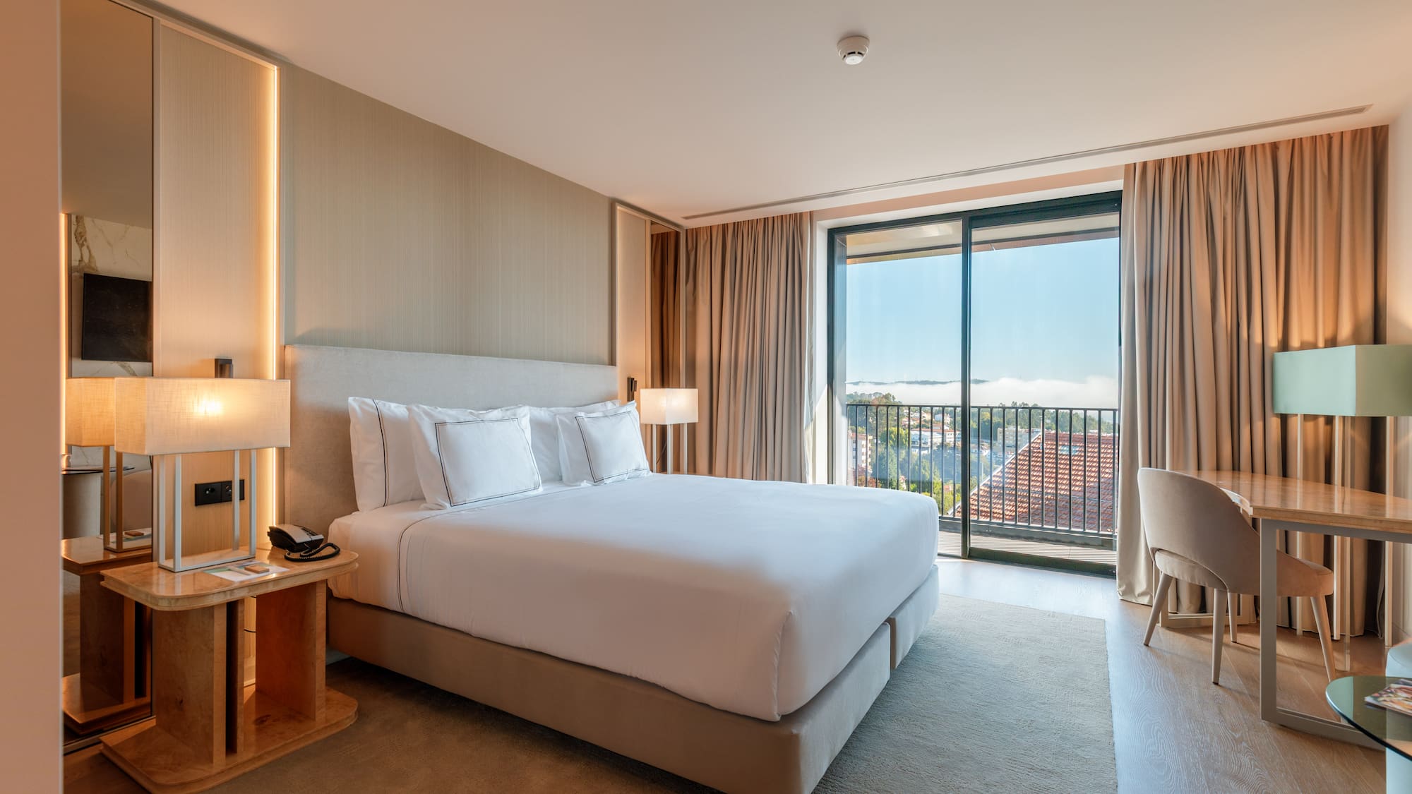 a bedroom with a bed and a table and chairs