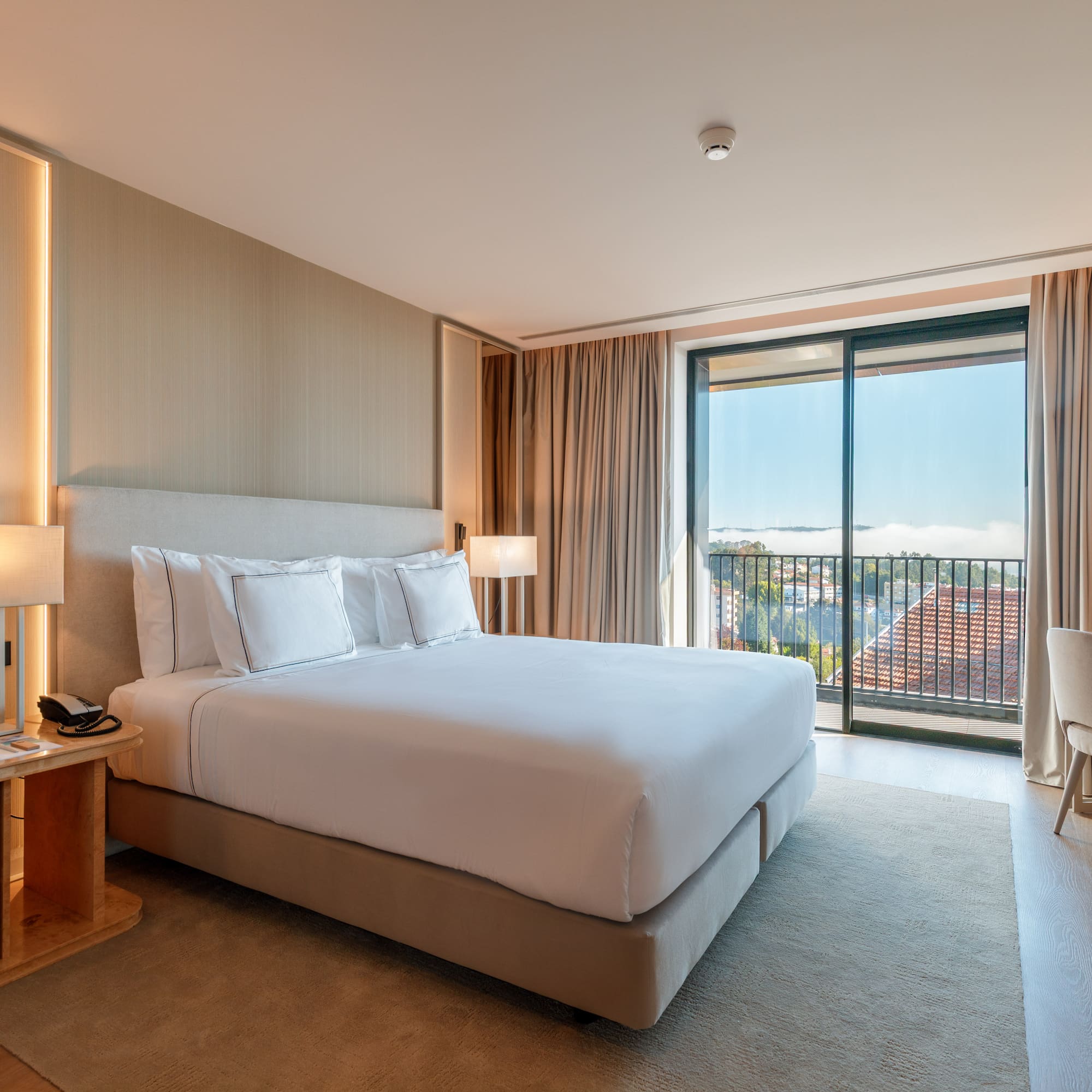 a bedroom with a bed and a table and chairs