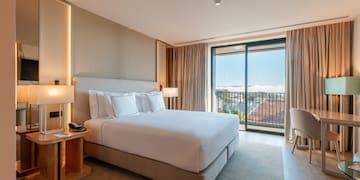 a bedroom with a bed and a table and chairs