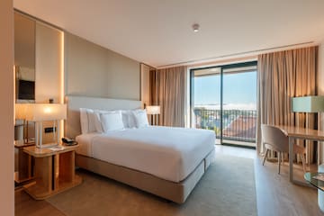 a bedroom with a bed and a table and chairs