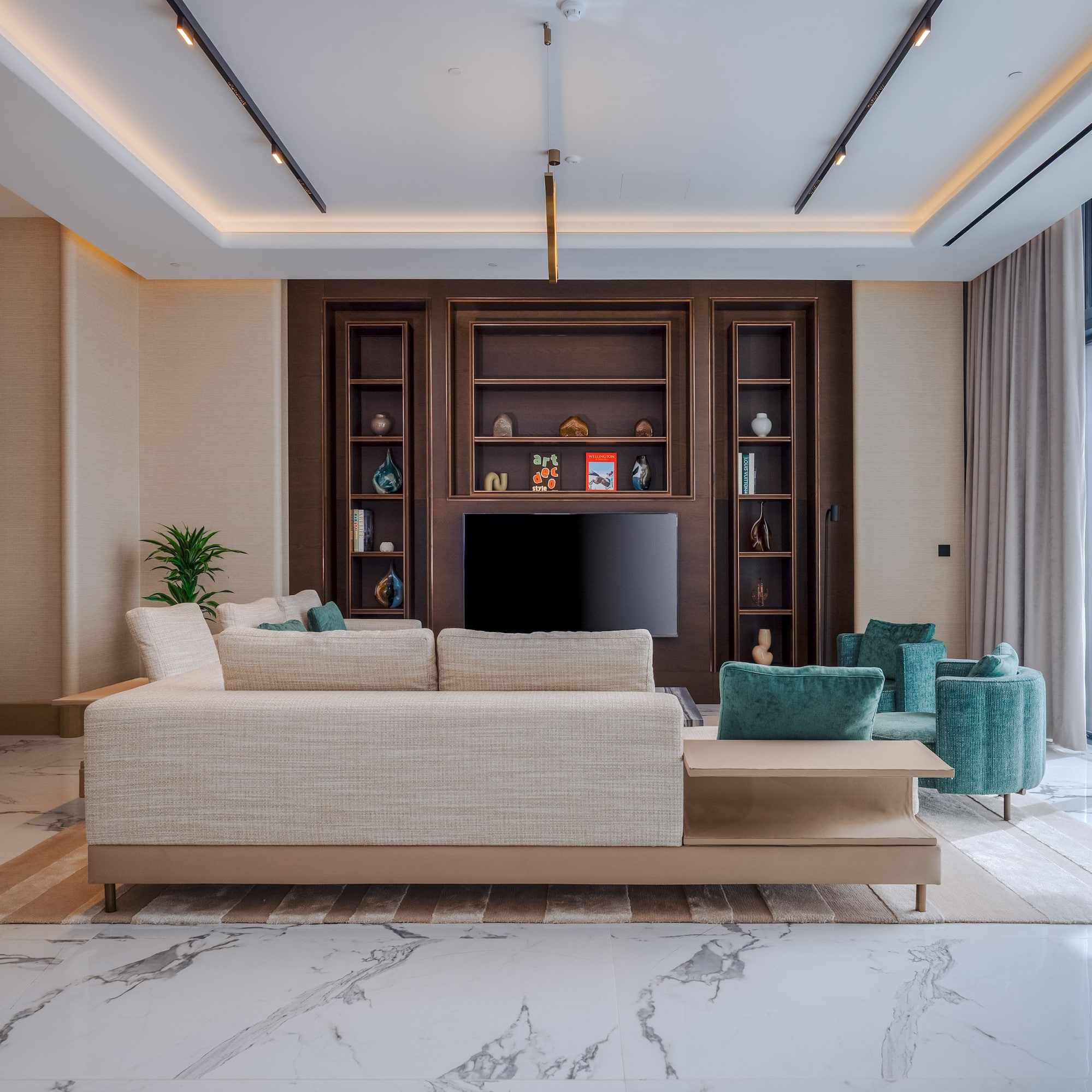 Modern living room, light sofa, dark wood media, marble floor, ocean view.