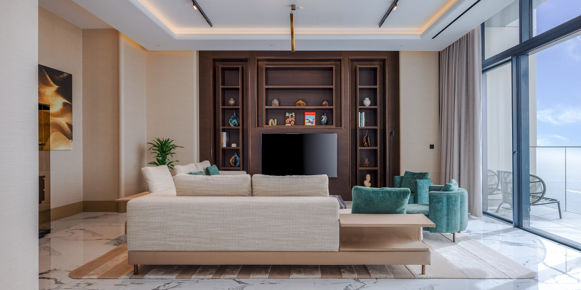 Modern living room, light sofa, dark wood media, marble floor, ocean view.