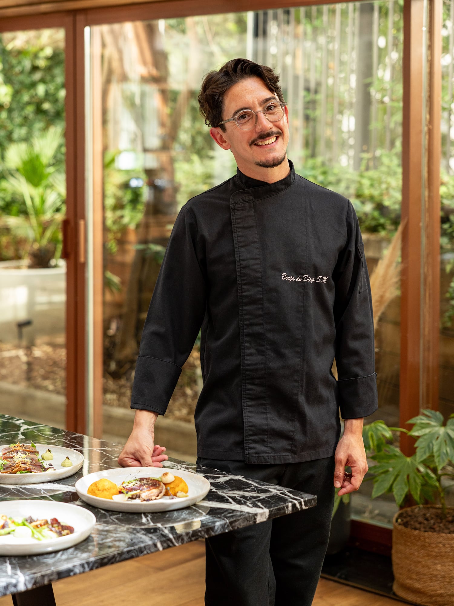 a man standing in front of a table with food on it