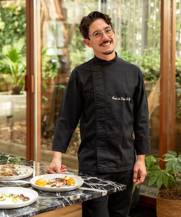 a man standing in front of a table with food on it