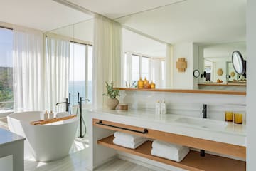 a bathroom with a tub and a bathtub