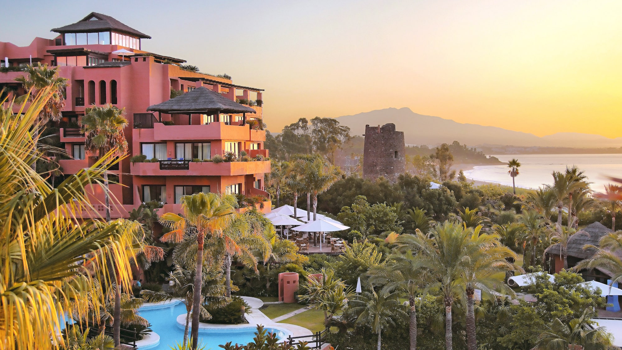 a building with a pool and trees