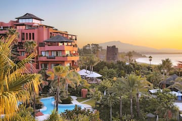 a building with a pool and trees
