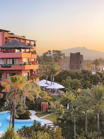 a building with a pool and trees