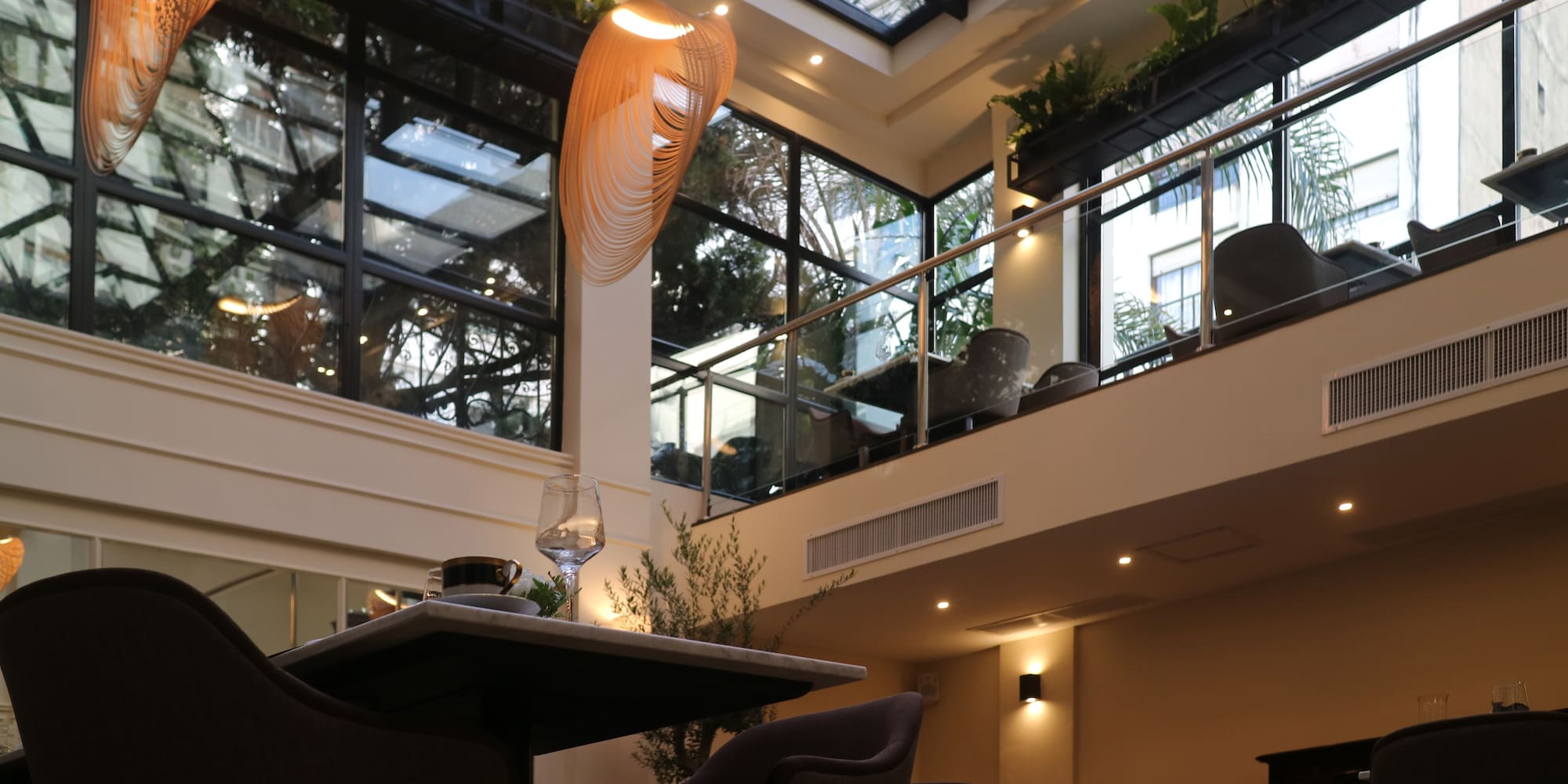 a room with a glass roof and a table and chairs