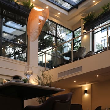 a room with a glass roof and a table and chairs