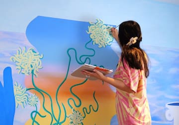 a woman painting a wall