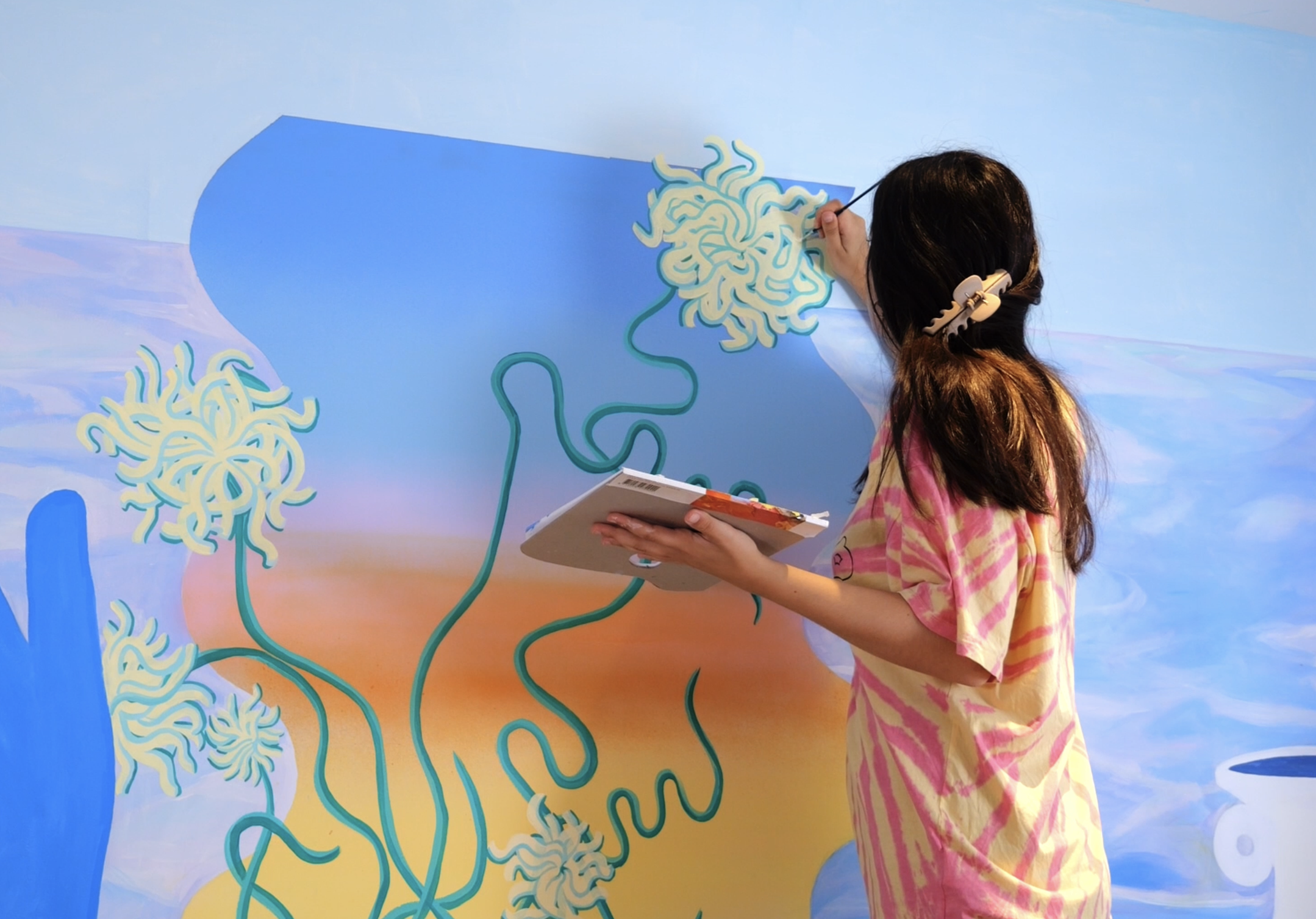 a woman painting a wall