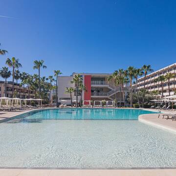 a pool with lounge chairs and palm trees