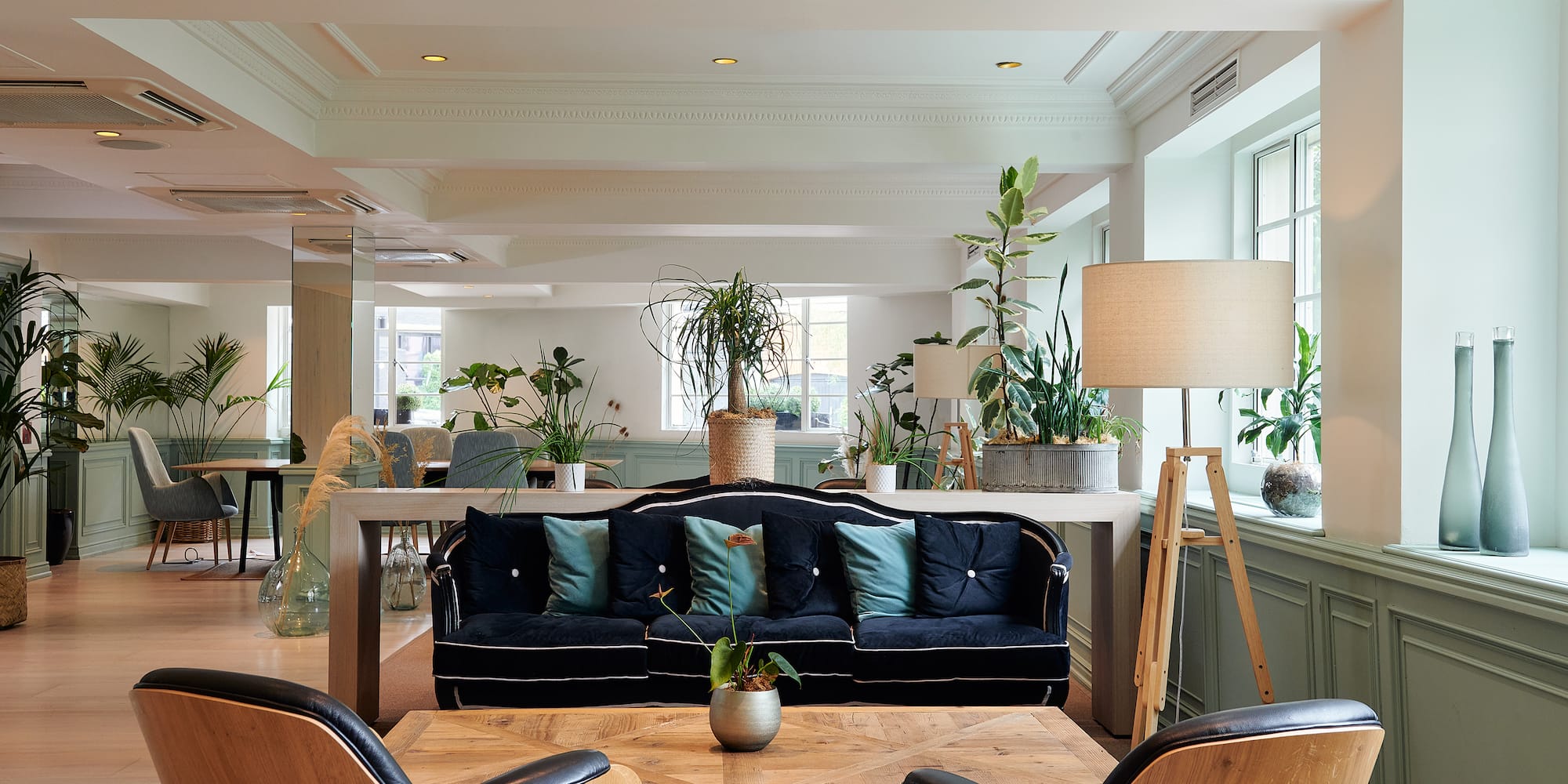 a room with a couch and chairs