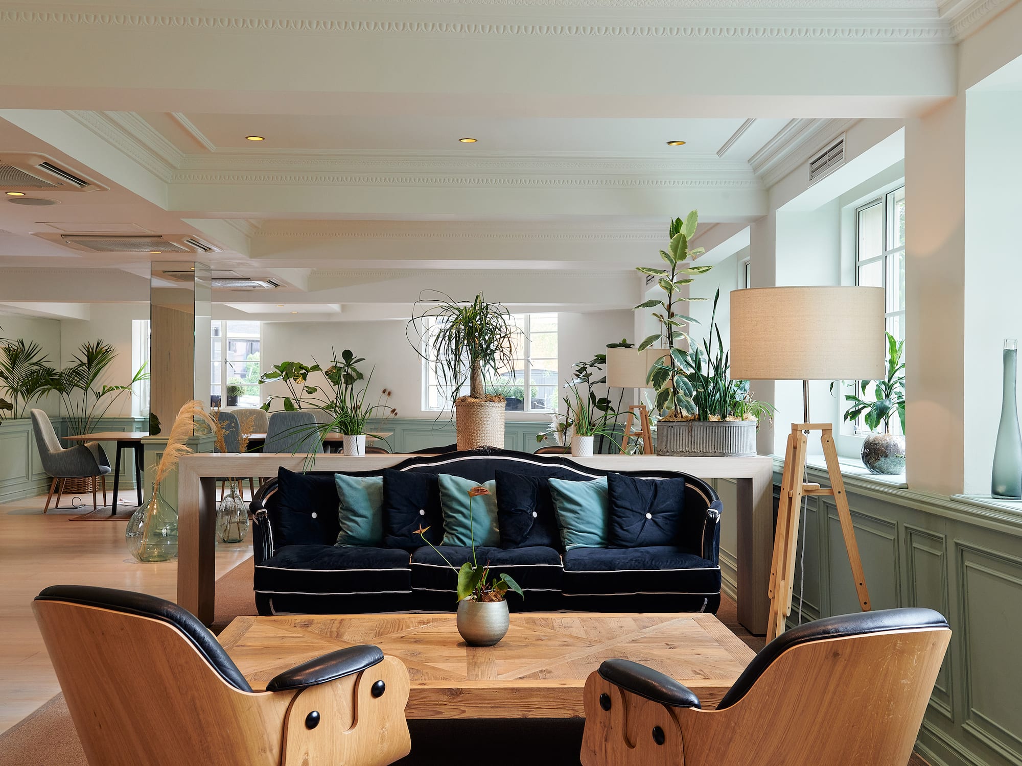 a room with a couch and chairs