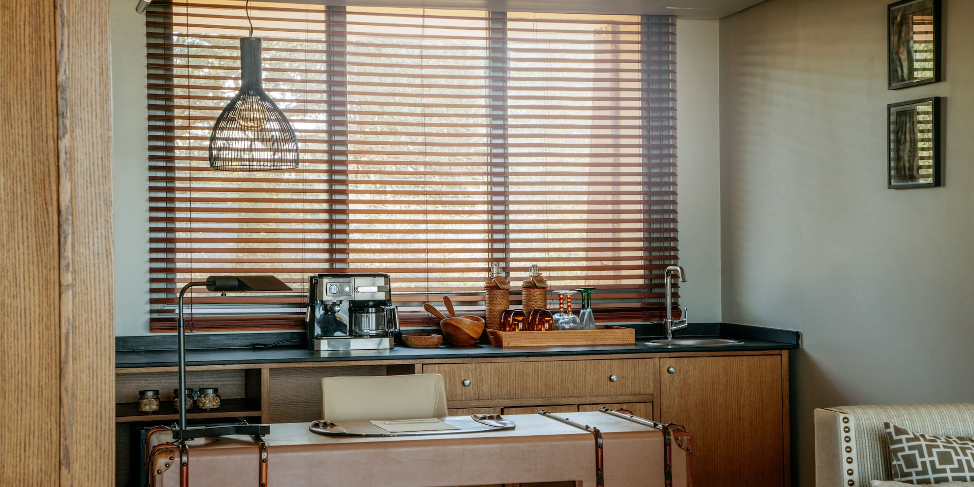 a kitchen with a table and a lamp