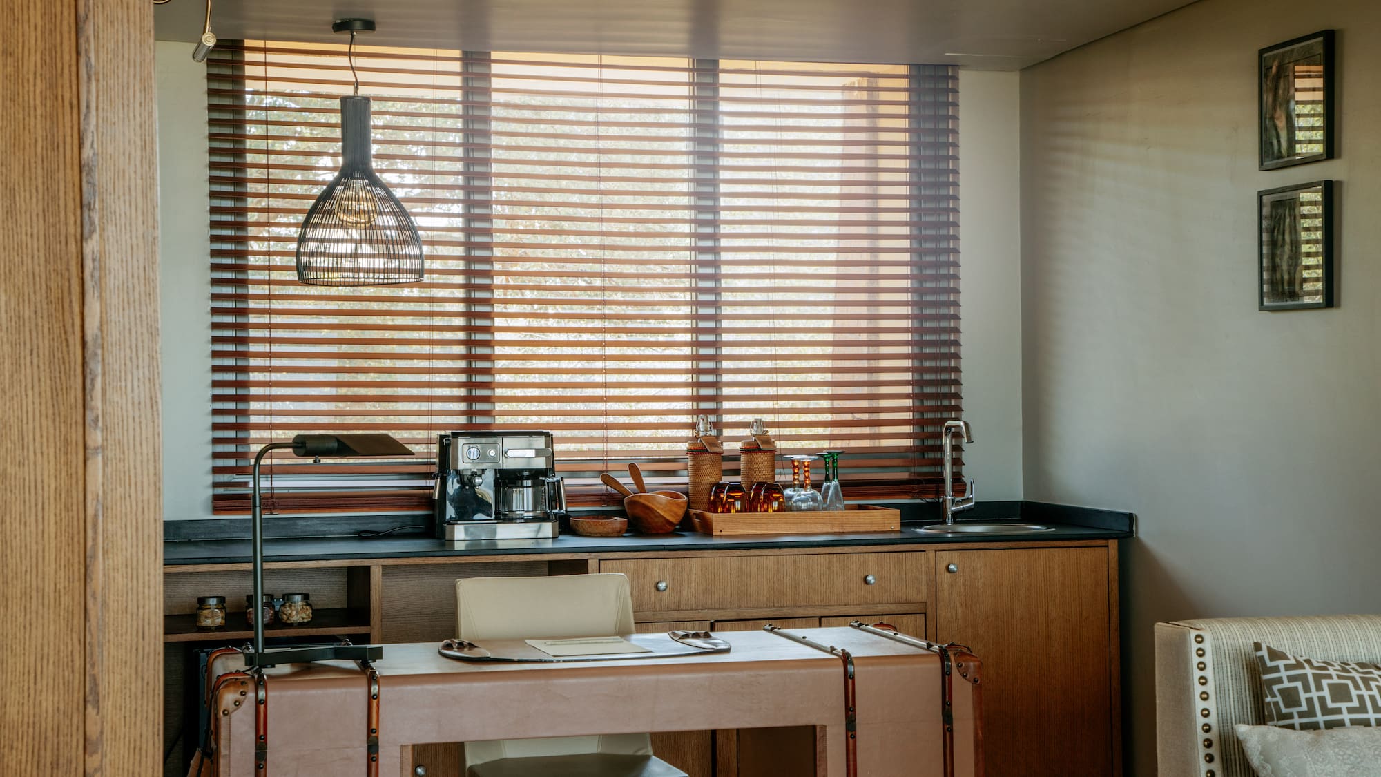 a kitchen with a table and a lamp