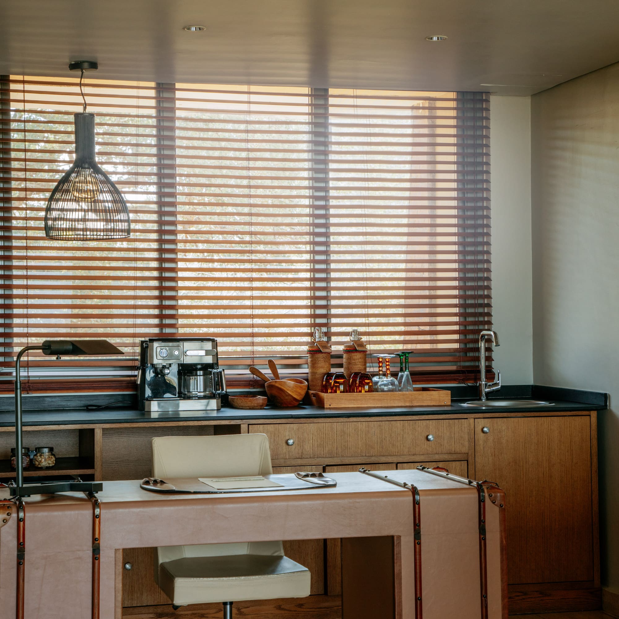 a kitchen with a table and a lamp