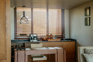 a kitchen with a table and a lamp