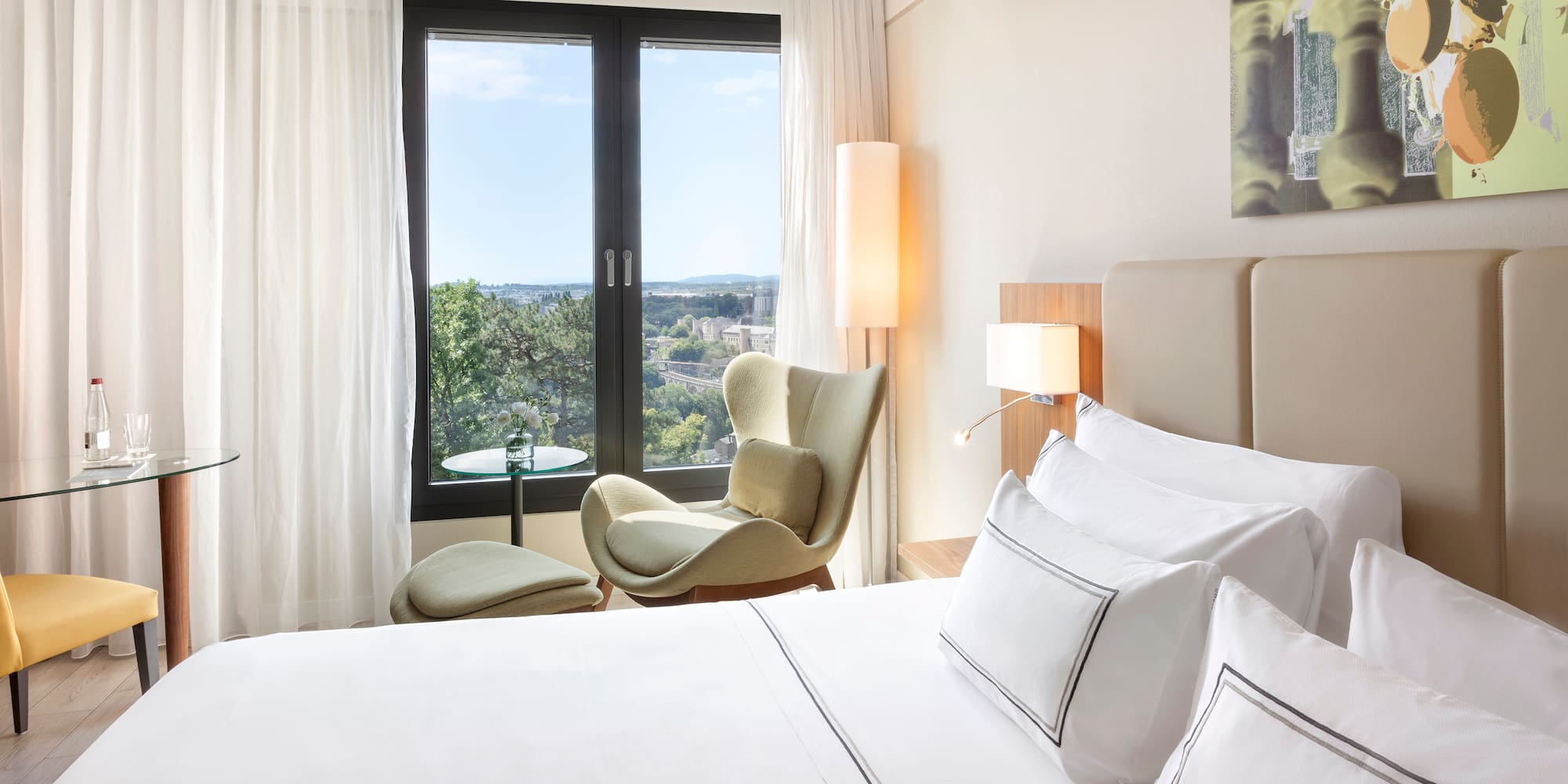 a bedroom with a bed and chairs