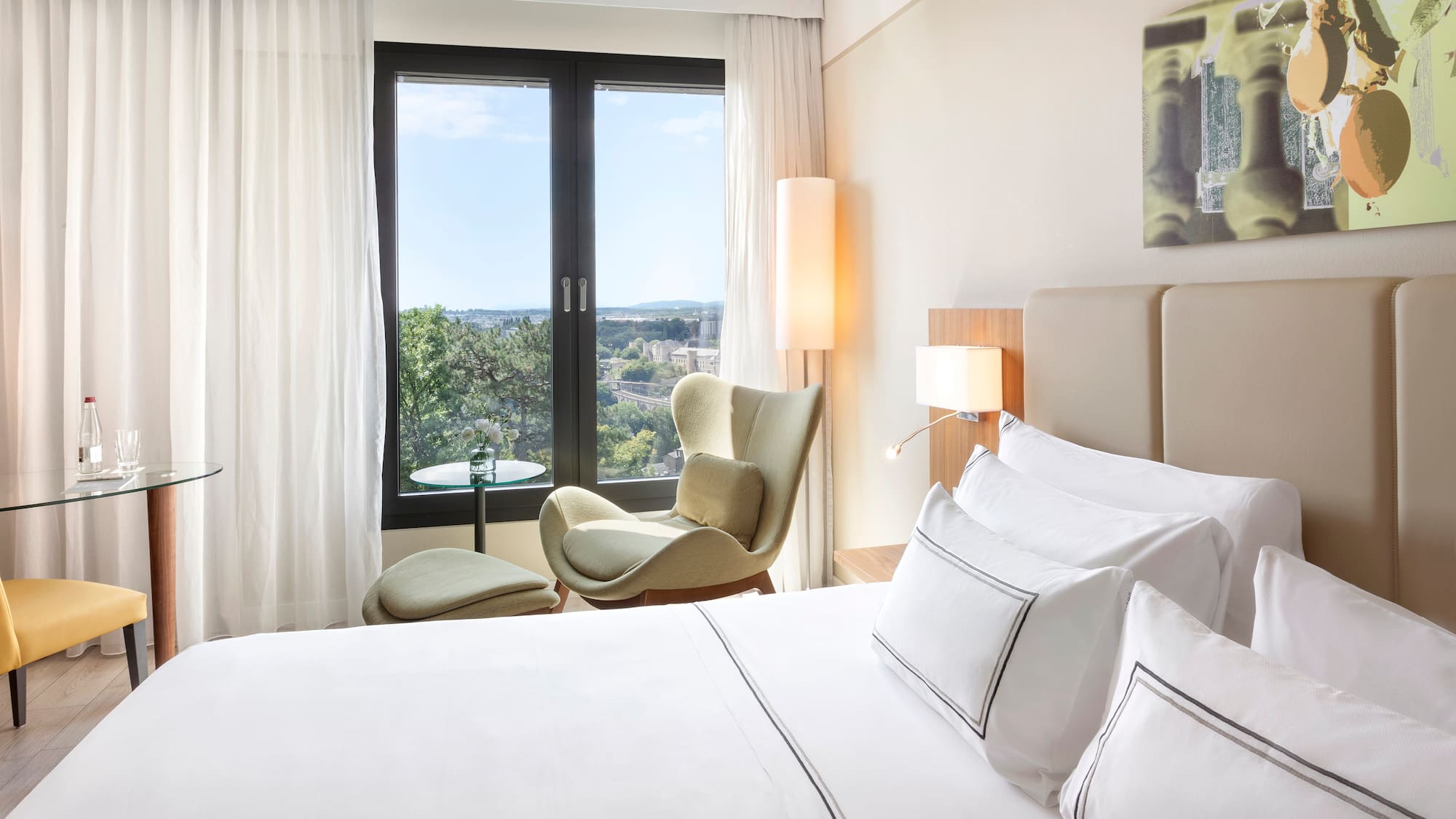 a bedroom with a bed and chairs