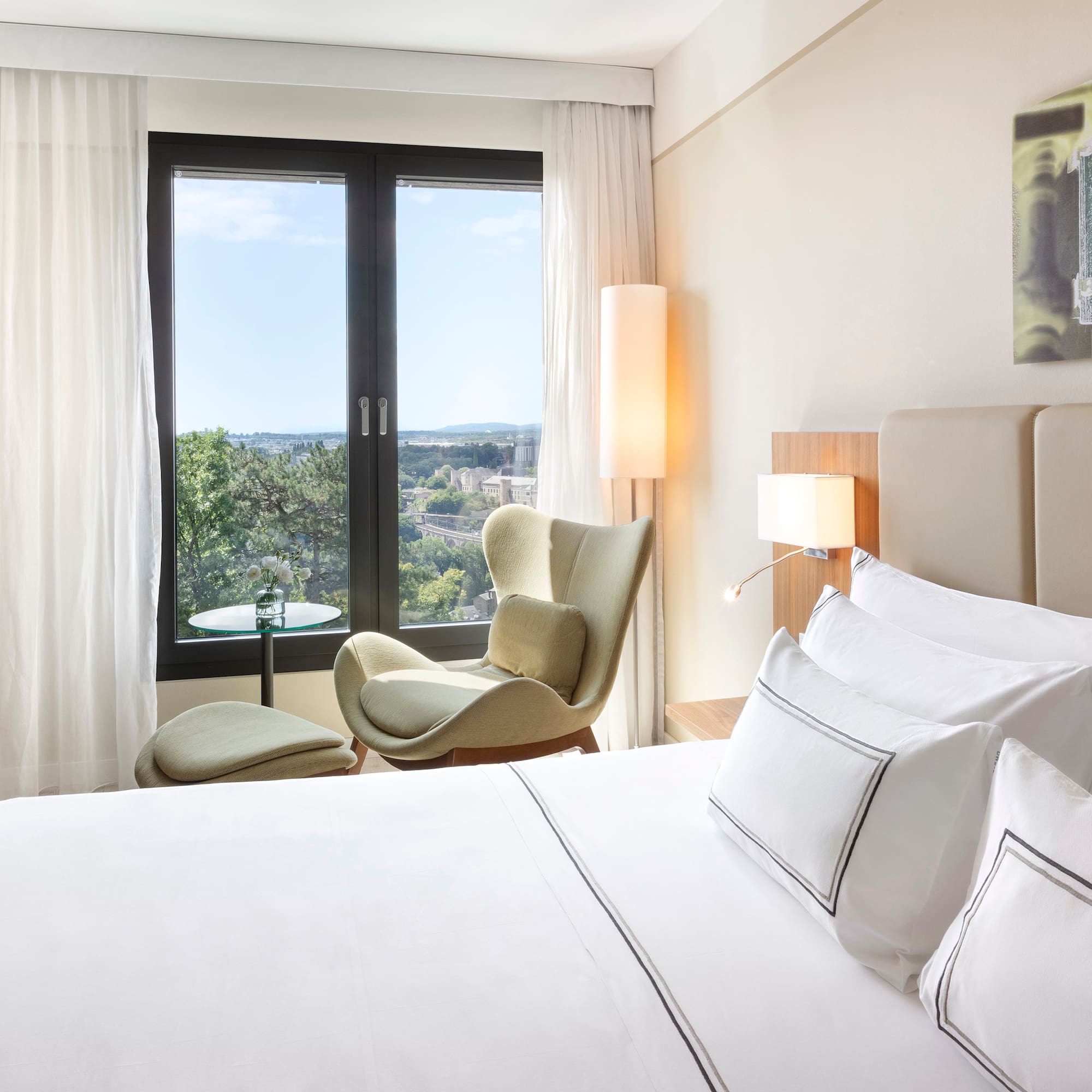 a bedroom with a bed and chairs