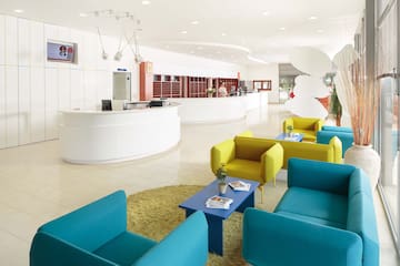 a reception area with blue and yellow chairs