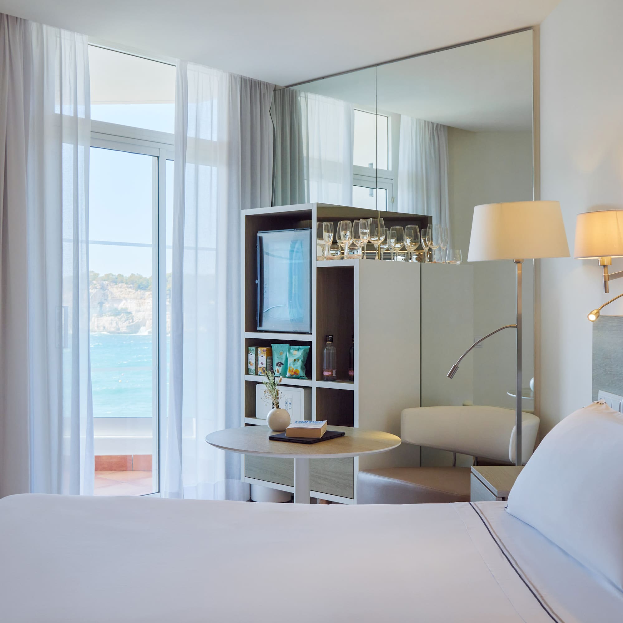 a room with a large mirror and a bed