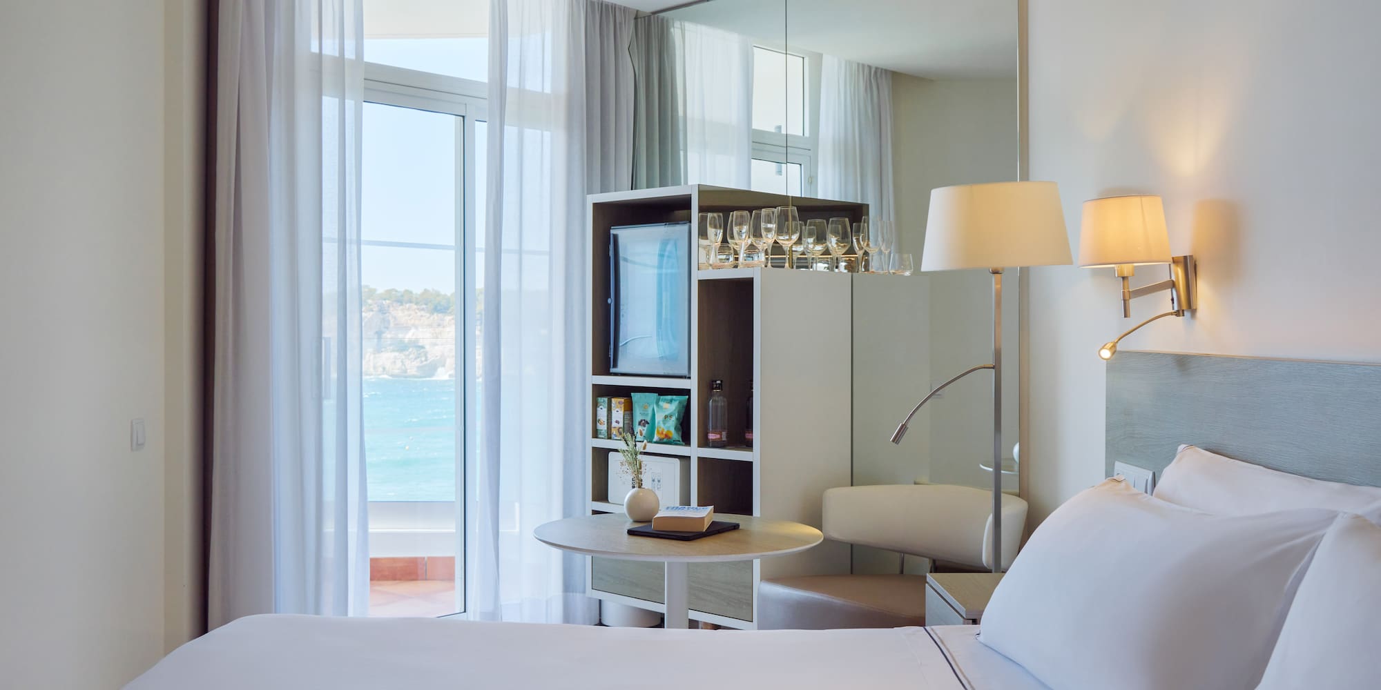 a room with a large mirror and a bed