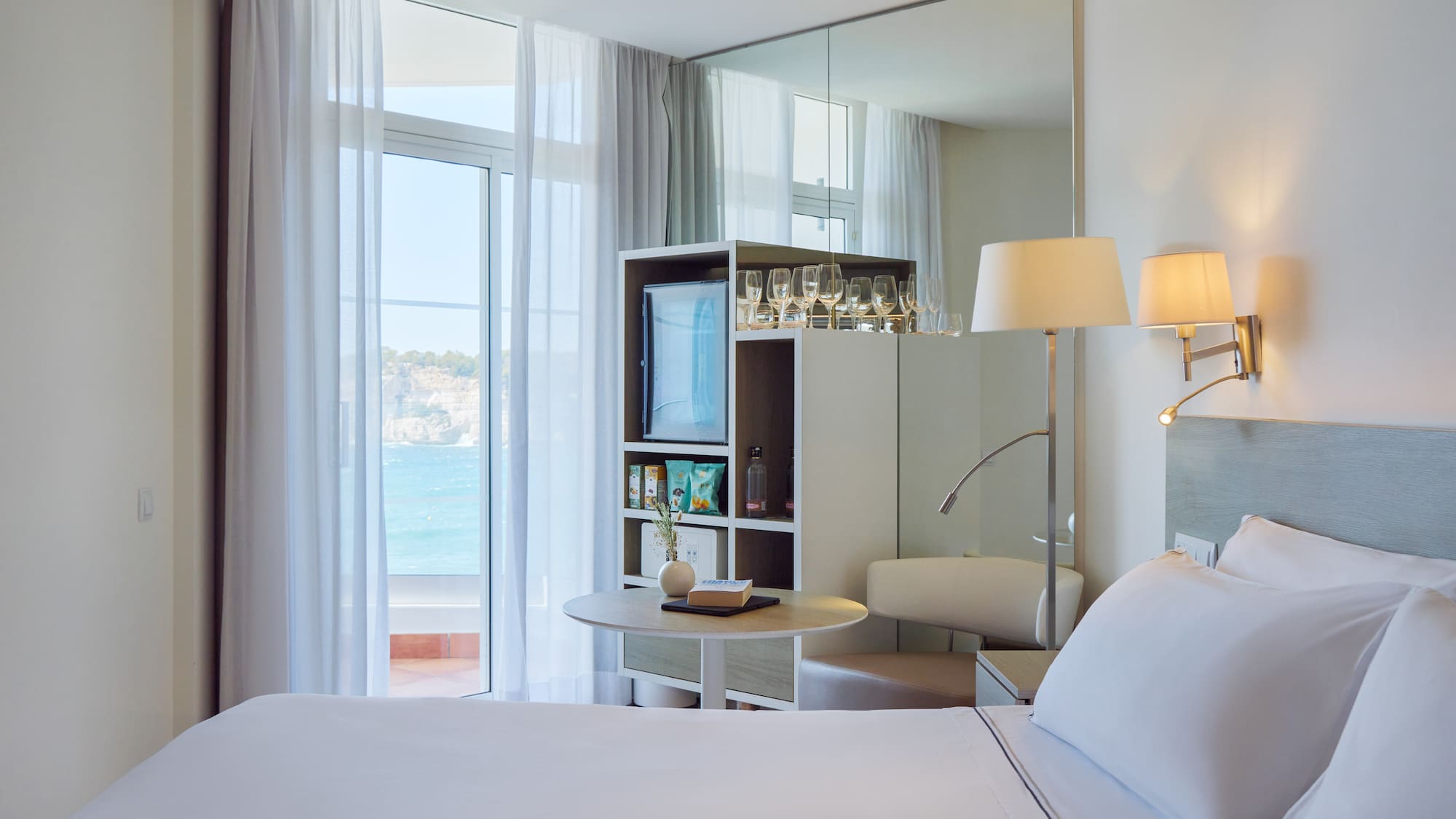 a room with a large mirror and a bed