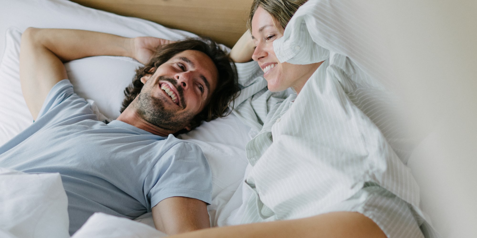 a man and woman lying in bed