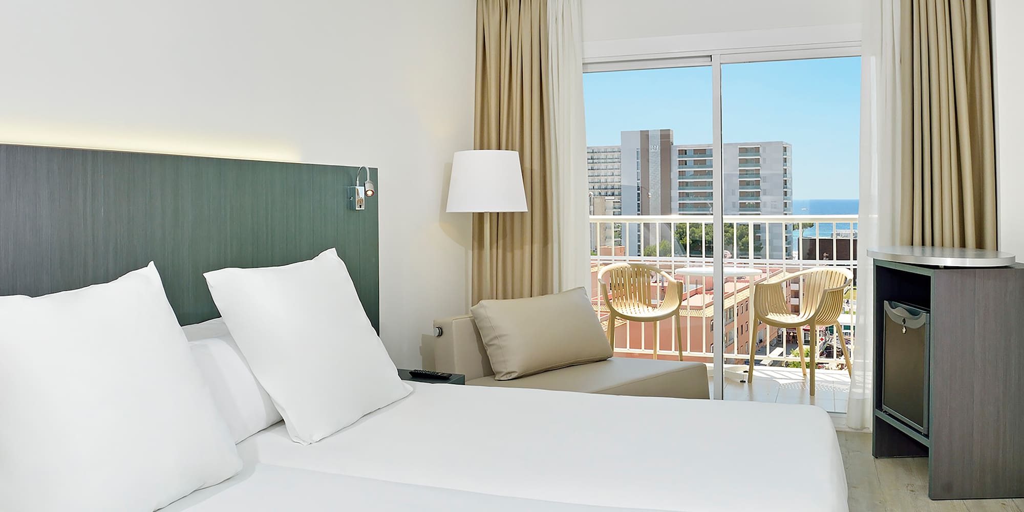 a hotel room with a balcony and a large bed