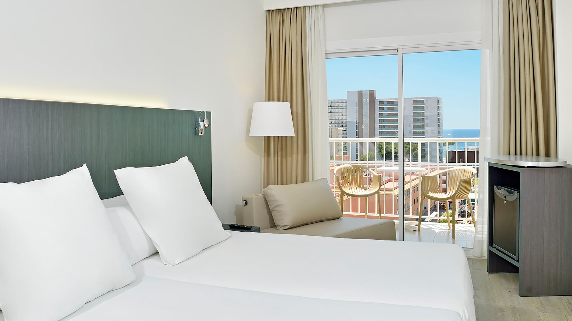 a hotel room with a balcony and a large bed