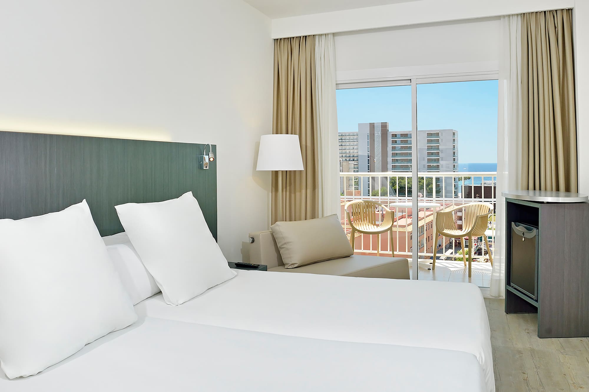 a hotel room with a balcony and a large bed
